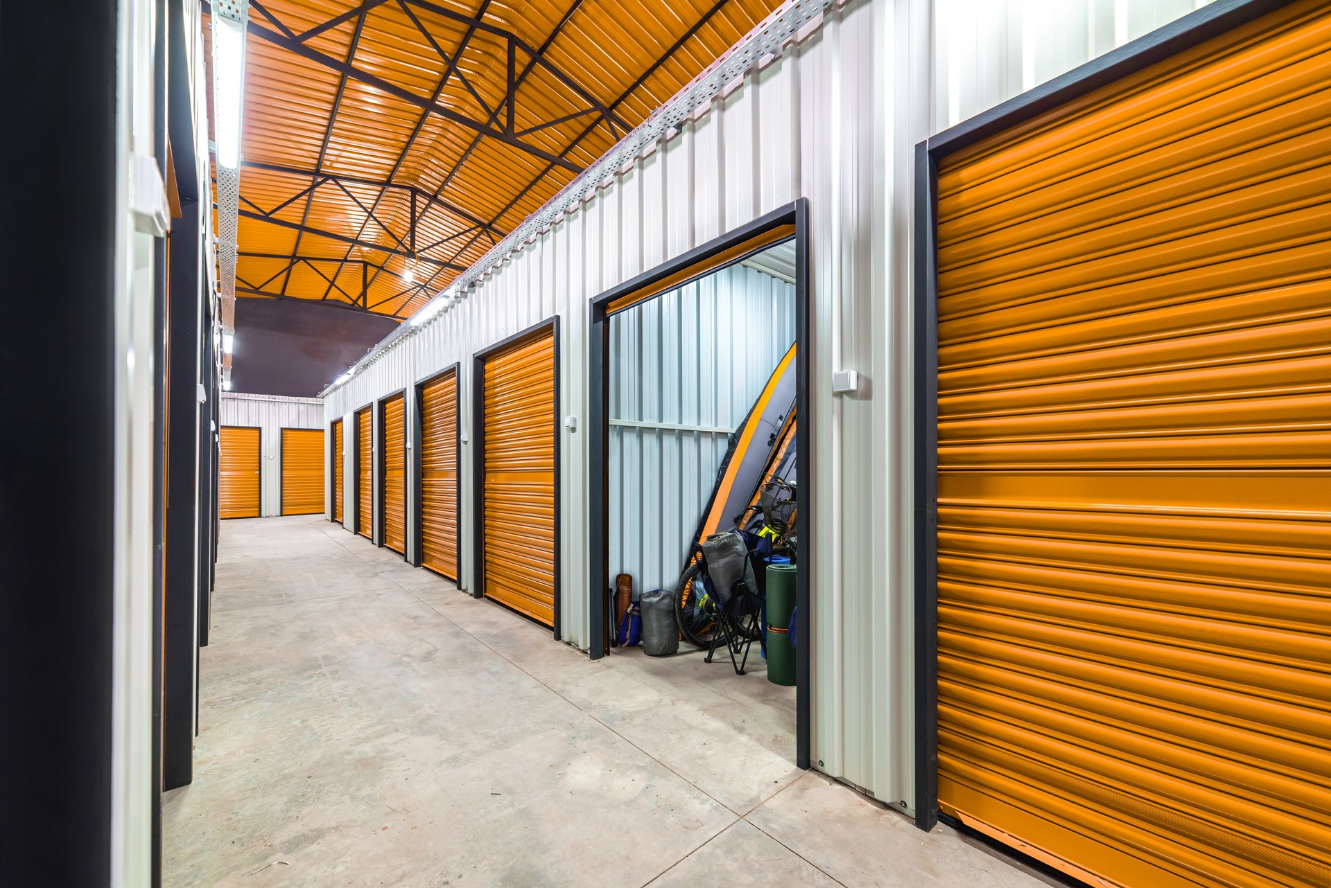 Corridor of self storage unit with yellow doors. Rental Storage Units