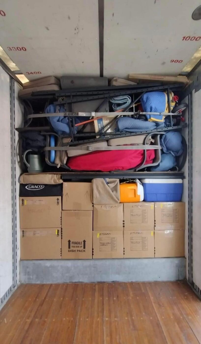 Moving truck packed with labeled kitchen boxes and fragile dish-pack boxes — DFW residential movers